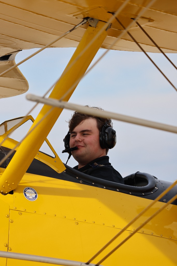 Landon Majer in yellow biplane cockpit